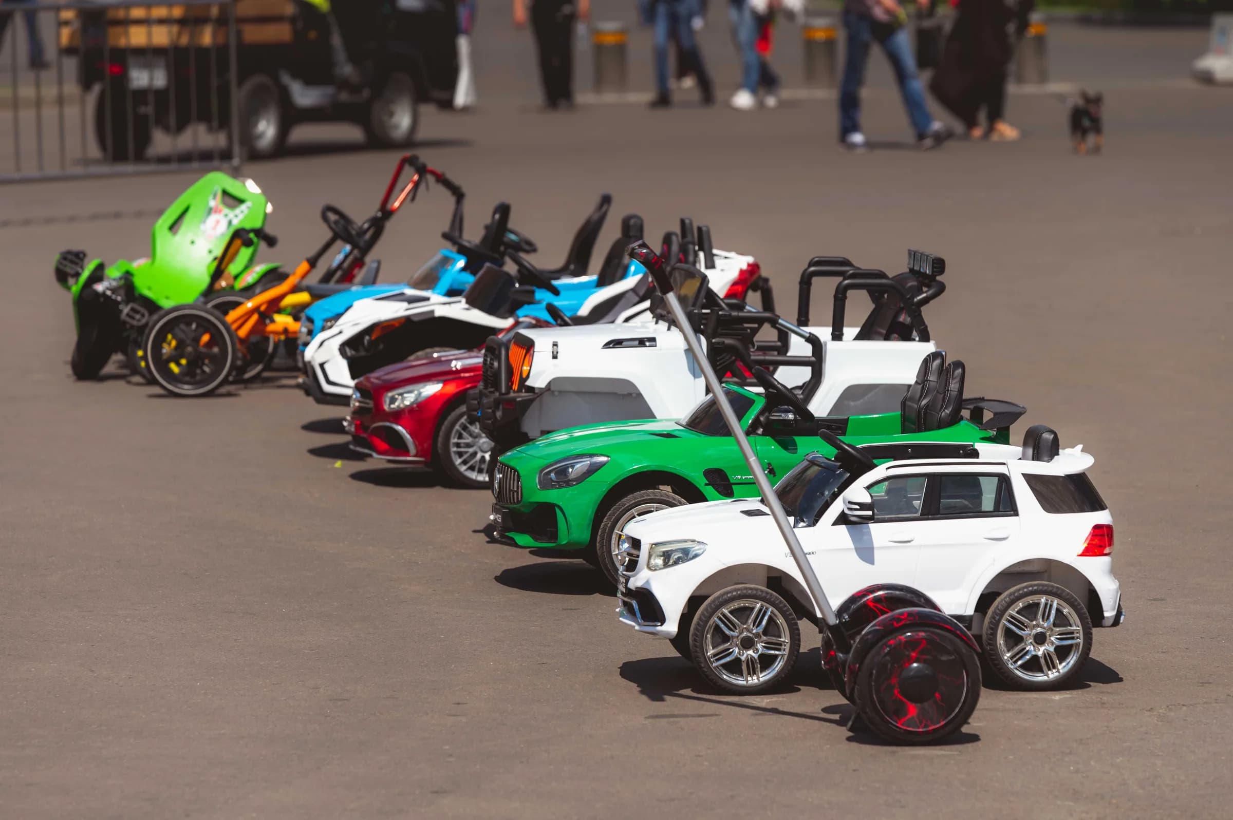 Child driving a battery-powered ride-on car outside
